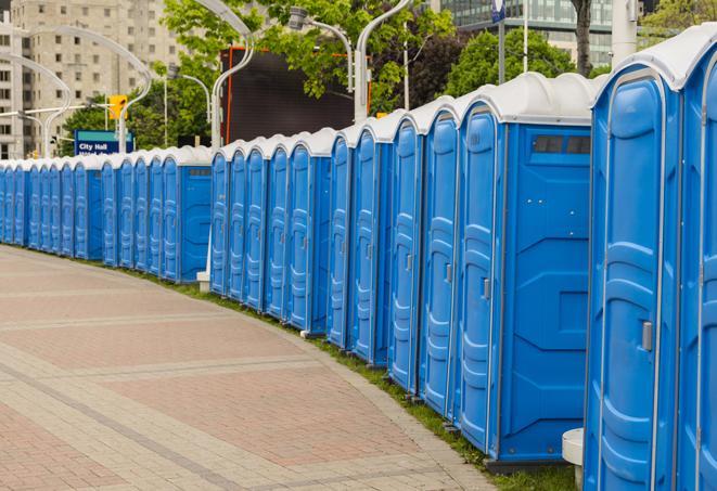 a row of portable restrooms set up for a large athletic event, allowing participants and spectators to easily take care of their needs in Bent Mountain VA